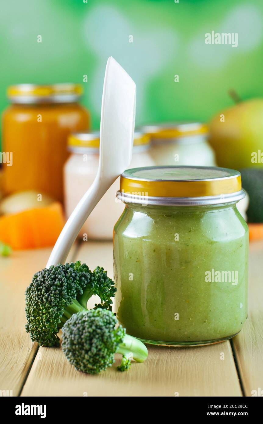 Jar with broccoli puree for baby with spoon Stock Photo