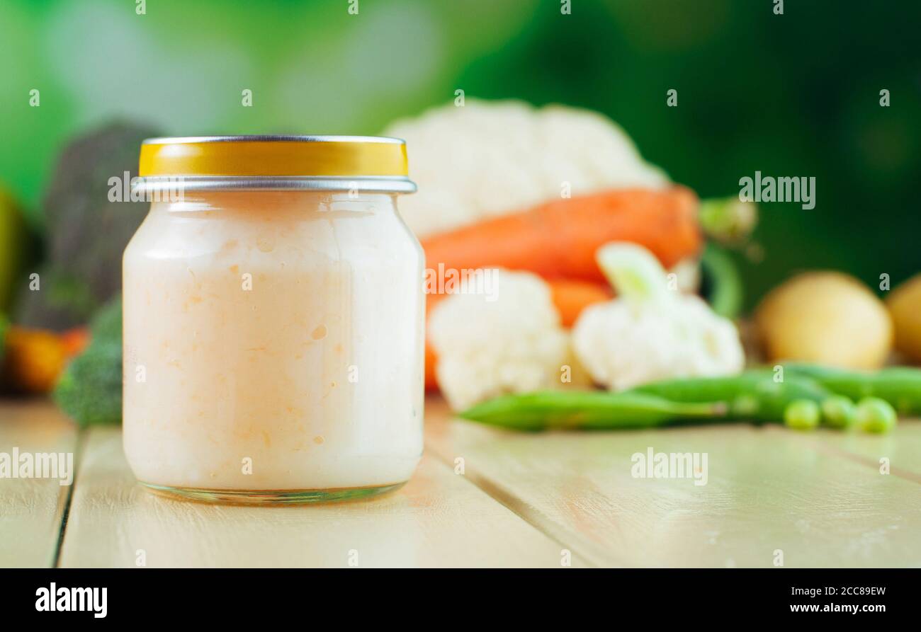 Jar with vegetable puree on the light wooden background Stock Photo