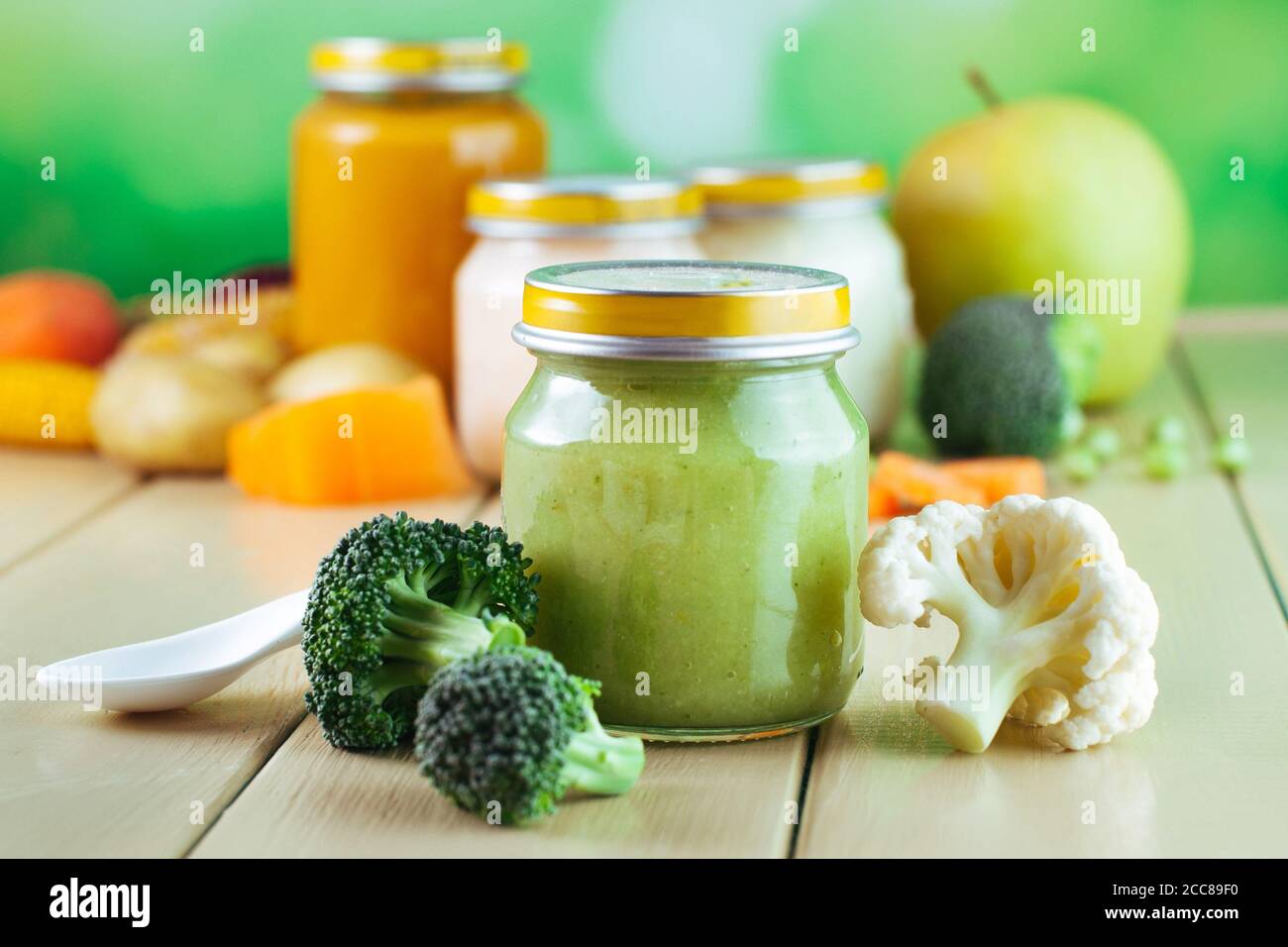 Jar with vegetable puree on the light wooden background Stock Photo
