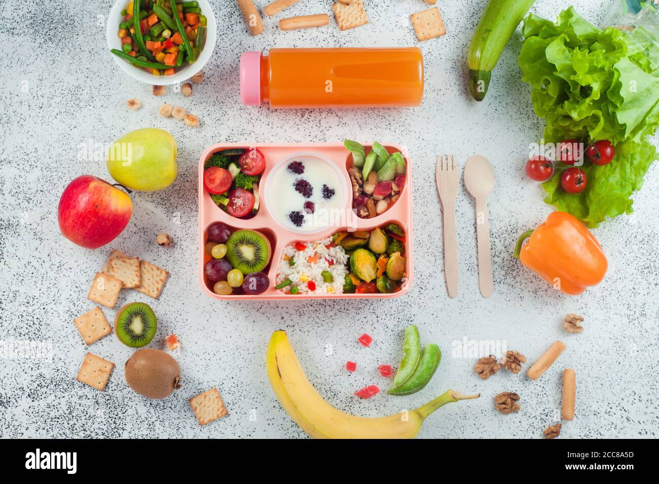https://c8.alamy.com/comp/2CC8A5D/lunch-box-with-vegetable-salad-berries-in-yogurt-fruits-and-rice-on-grey-background-with-ingredients-2CC8A5D.jpg