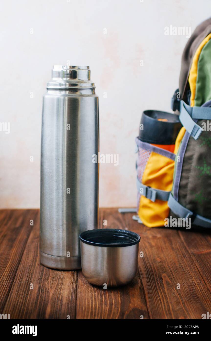 Open thermos bottle with boiling water on wooden background Stock Photo -  Alamy