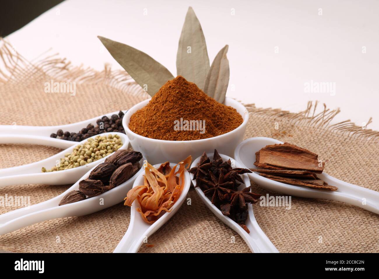 Indian Garam masala powder and colourful spices. Over burlup Stock Photo