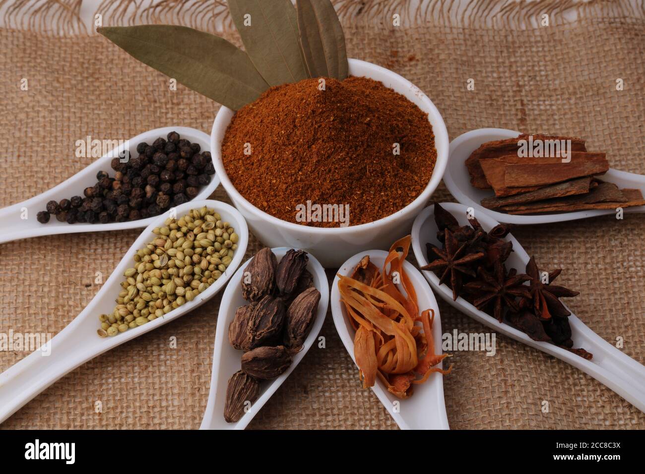 Indian Garam masala powder and colourful spices. Over burlup Stock Photo