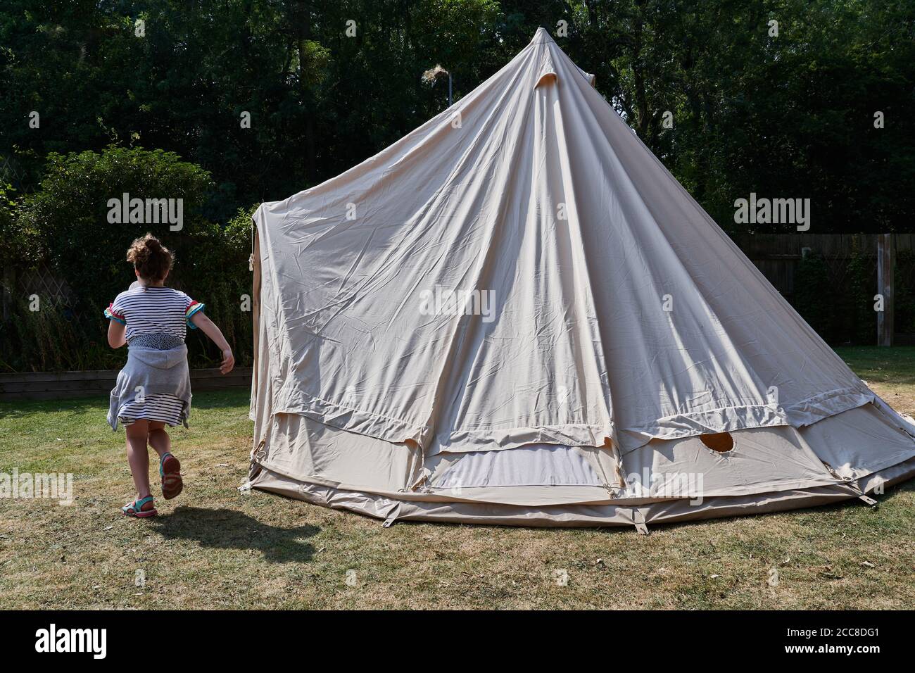 Bell shaped tepee tent semi-erected in back garden for staycation summer holiday during the coronavirus crisis, August 2020. Stock Photo