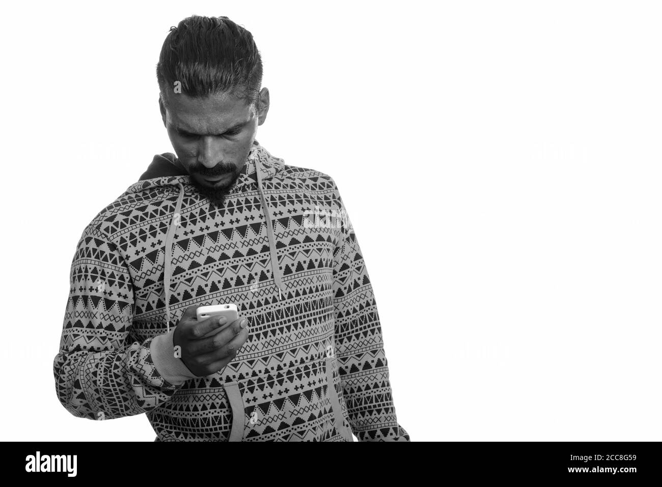Portrait of young handsome bearded Indian man using phone Stock Photo ...