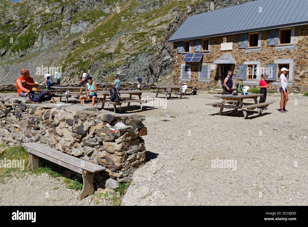 LA PRA, FRANCE, August 6, 2020 : A group of hikers rest for a while at the mountain refuge, with social distanciation respect. Stock Photo