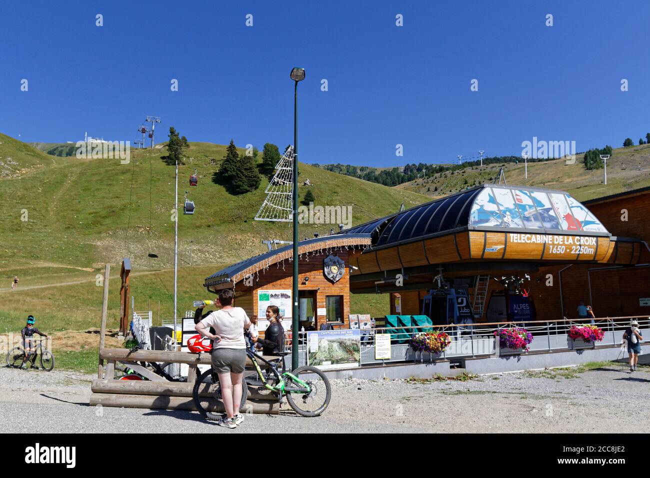 CHAMROUSSE, FRANCE, August 6, 2020 : Mountain bikers waiting for a cable-car cabin. Well-known ski resort near Grenoble, Chamrousse is a summer destin Stock Photo