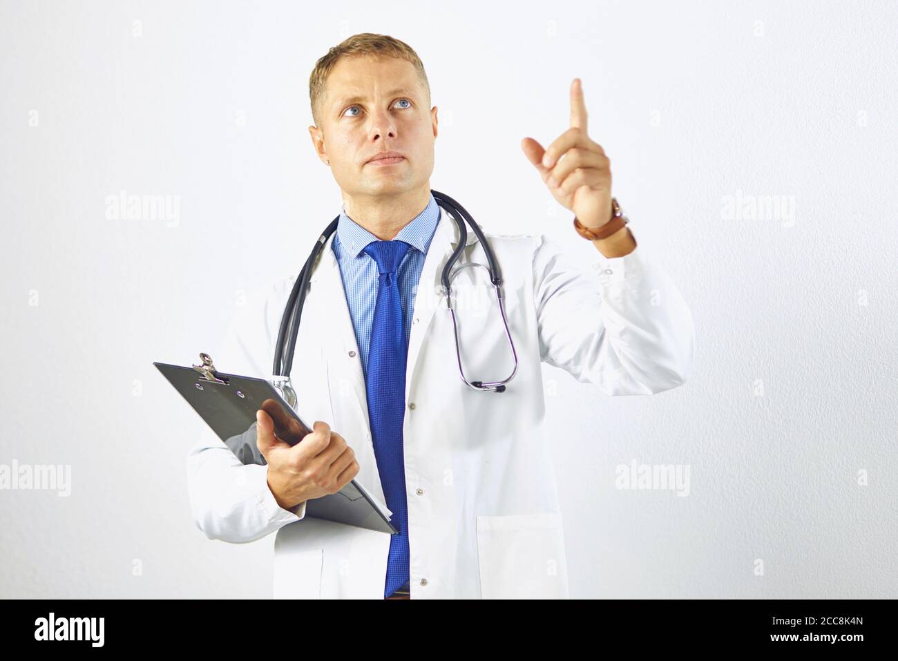Young confident doctor in a white coat with a stethoscope Stock Photo ...
