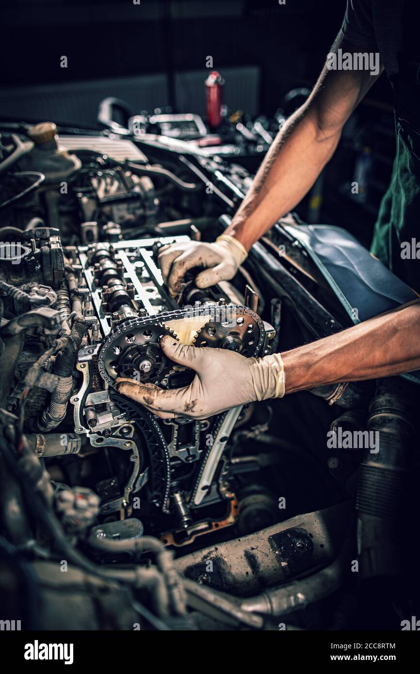 Automobile mechanic repairman hands repairing a car. Car service and maintenance concept Stock Photo