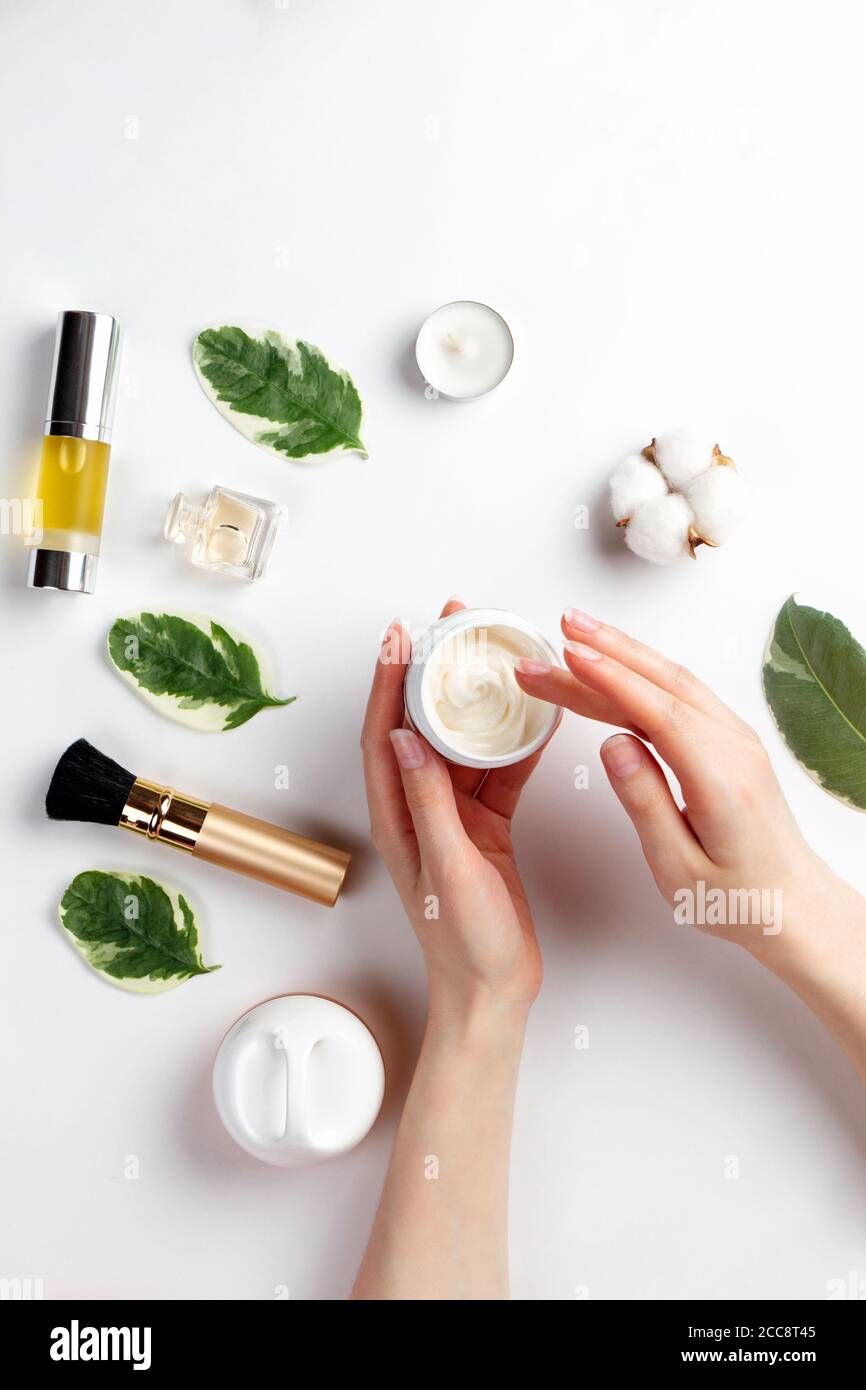 Cosmetics and self-care. Female hands hold a jar of cream and is about ...