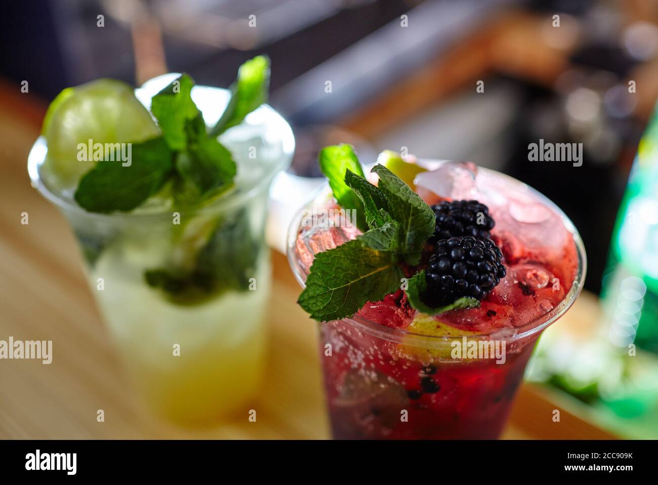 Mojito cocktails or soda drink with lime,fruits and mint on bar counter.Blurred image,selective focus Stock Photo