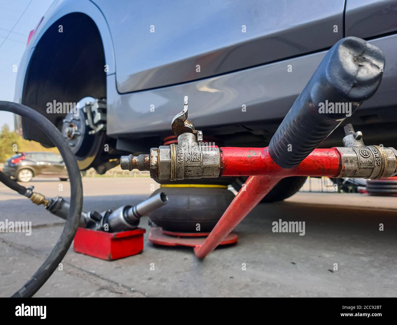 Tire. Seasonal change of car tires. Car without a wheel on a jack Stock