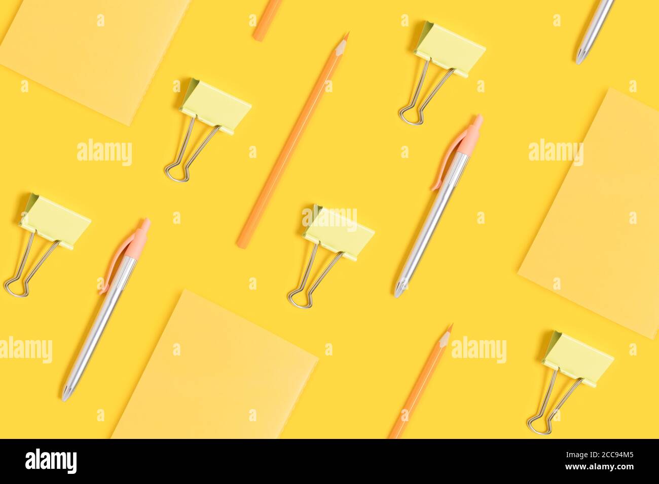 School supplies pattern on a yellow background. Monochrome creative layout. Stock Photo