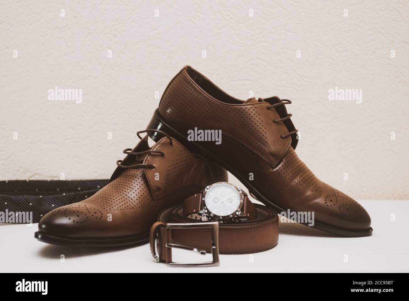 Brown wedding shoes for man with belt and watch Stock Photo