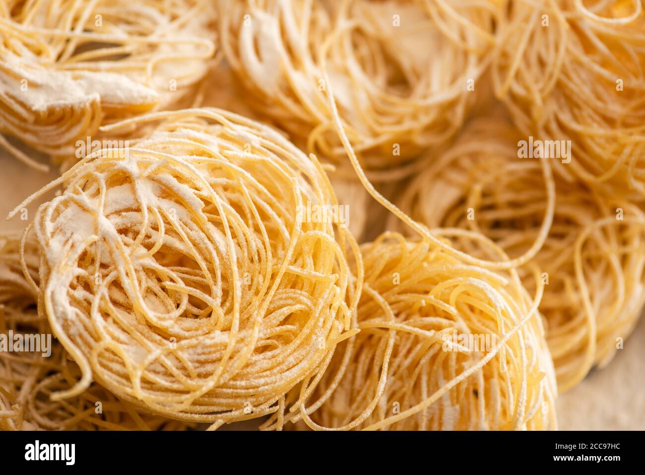 close up view of raw Italian Capellini with flour Stock Photo Alamy