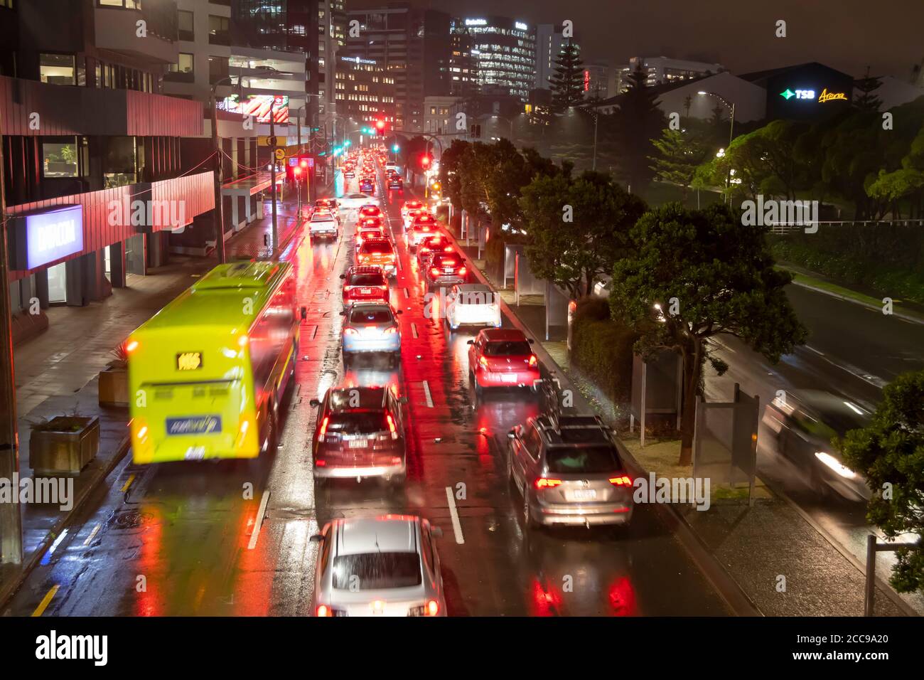 Traffic waiting at traffic lights at night in Wellington, North Island, New Zealand Stock Photo