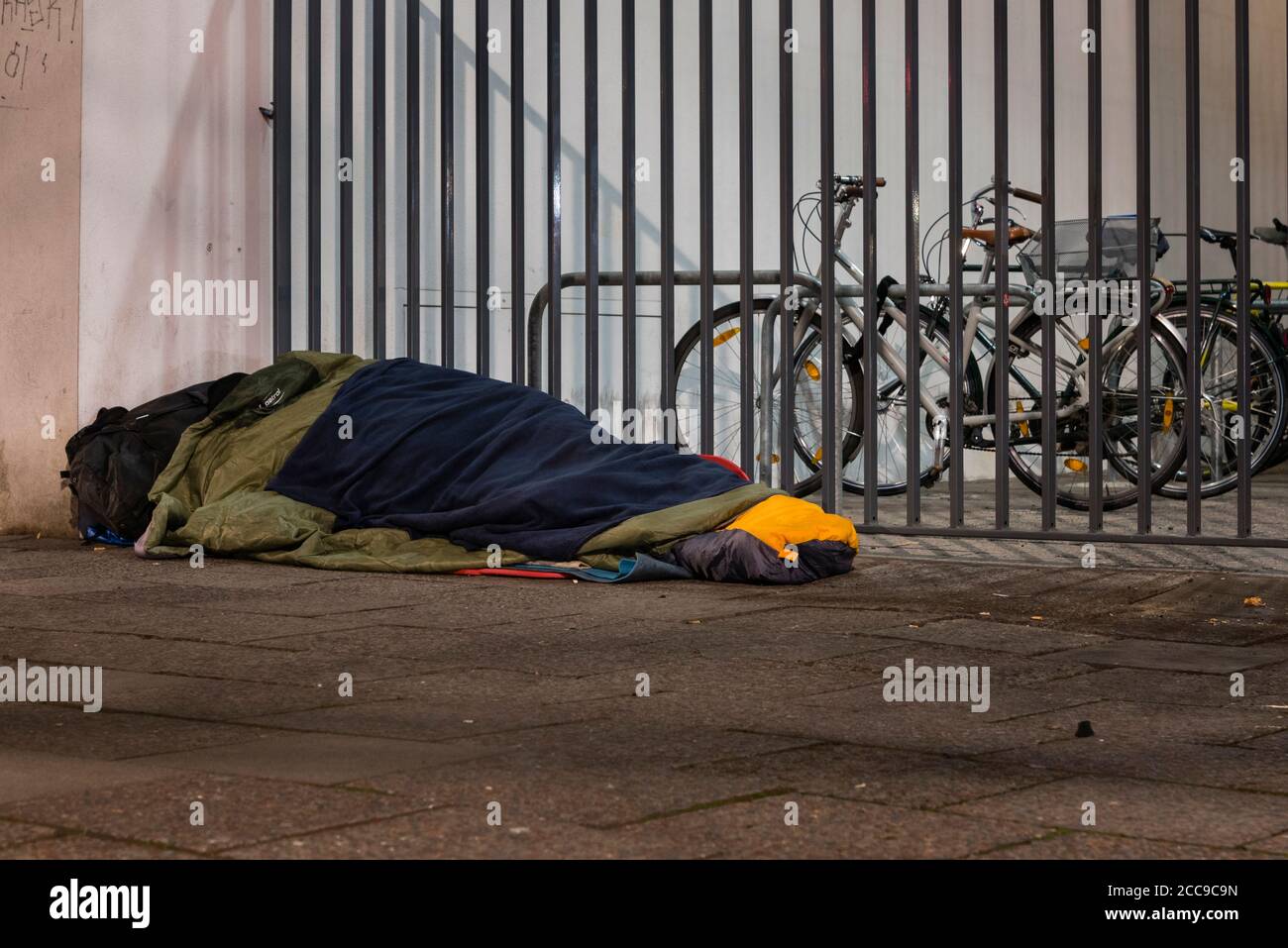 Homeless man sleeping in winter, homeless man in sleeping bag on the