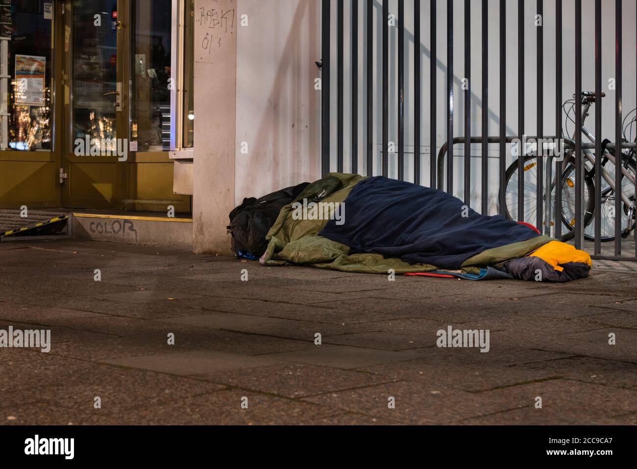 Homeless man sleeping in winter, homeless man in sleeping bag on the