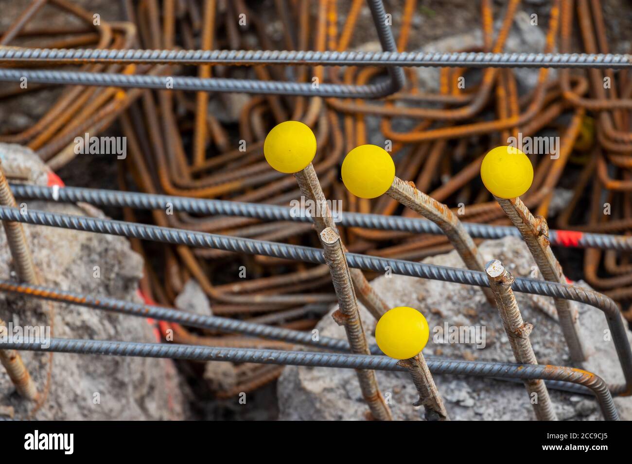 Steel reinforcement rebars with yellow protection caps. Covers protect