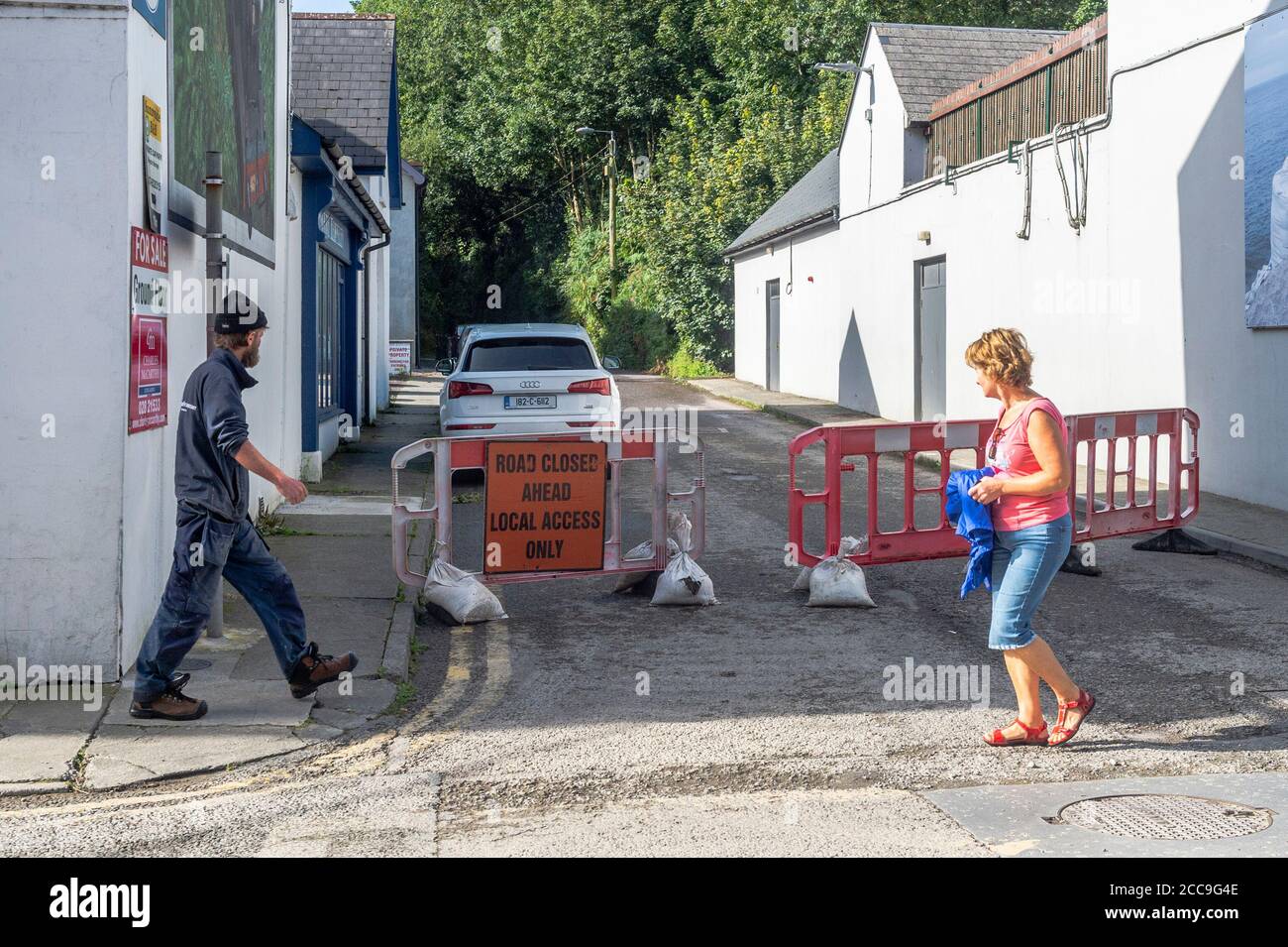 Skibbereen, West Cork, Ireland. 20th Aug, 2020. The Cutting in Skibbereen is closed today as emergency repairs are being carried out to a culvert after floods last night affected some 15 businesses in the town. A contractor is installing 'trash screens' to prevent drains becoming blocked. Credit: AG News/Alamy Live News Stock Photo