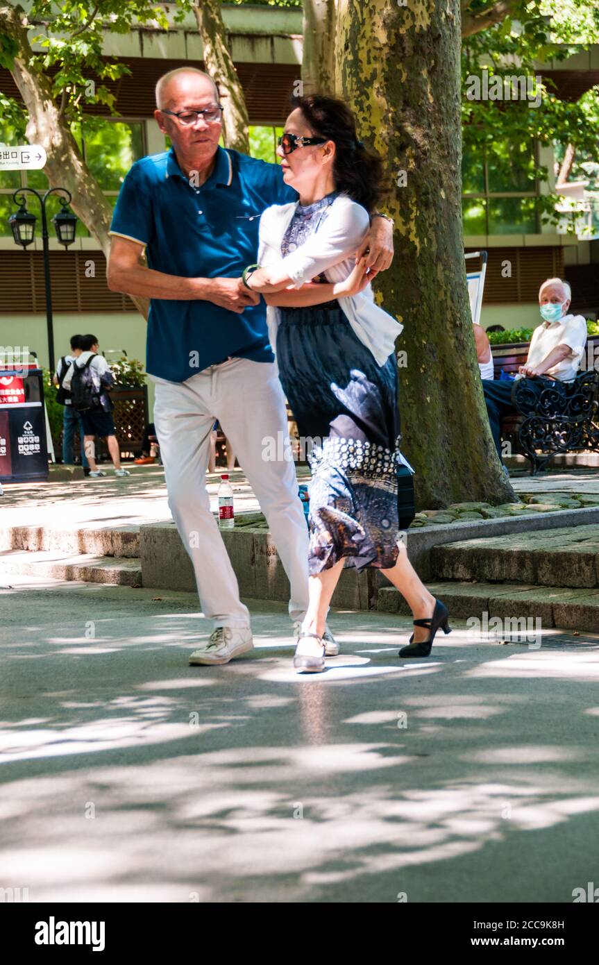 A couple dancing in Shanghai’s Fuxing Park. Stock Photo
