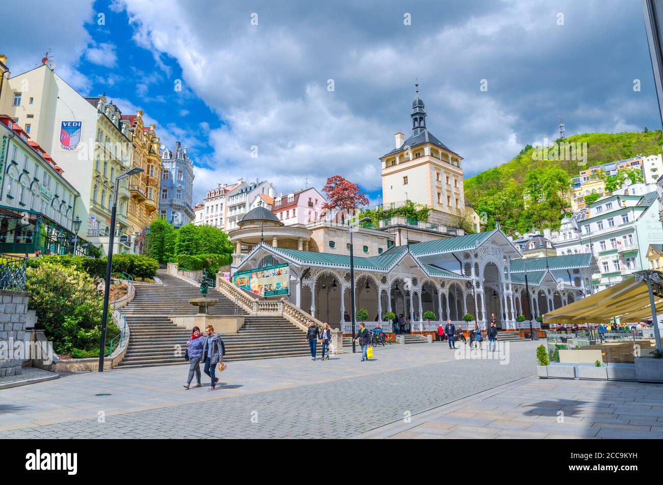 Karlovy Vary, Czech Republic, May 10, 2019: The Market Colonnade Trzni kolonada wooden colonnade with hot springs and people are walking in town Carlsbad historical city centre, West Bohemia Stock Photo