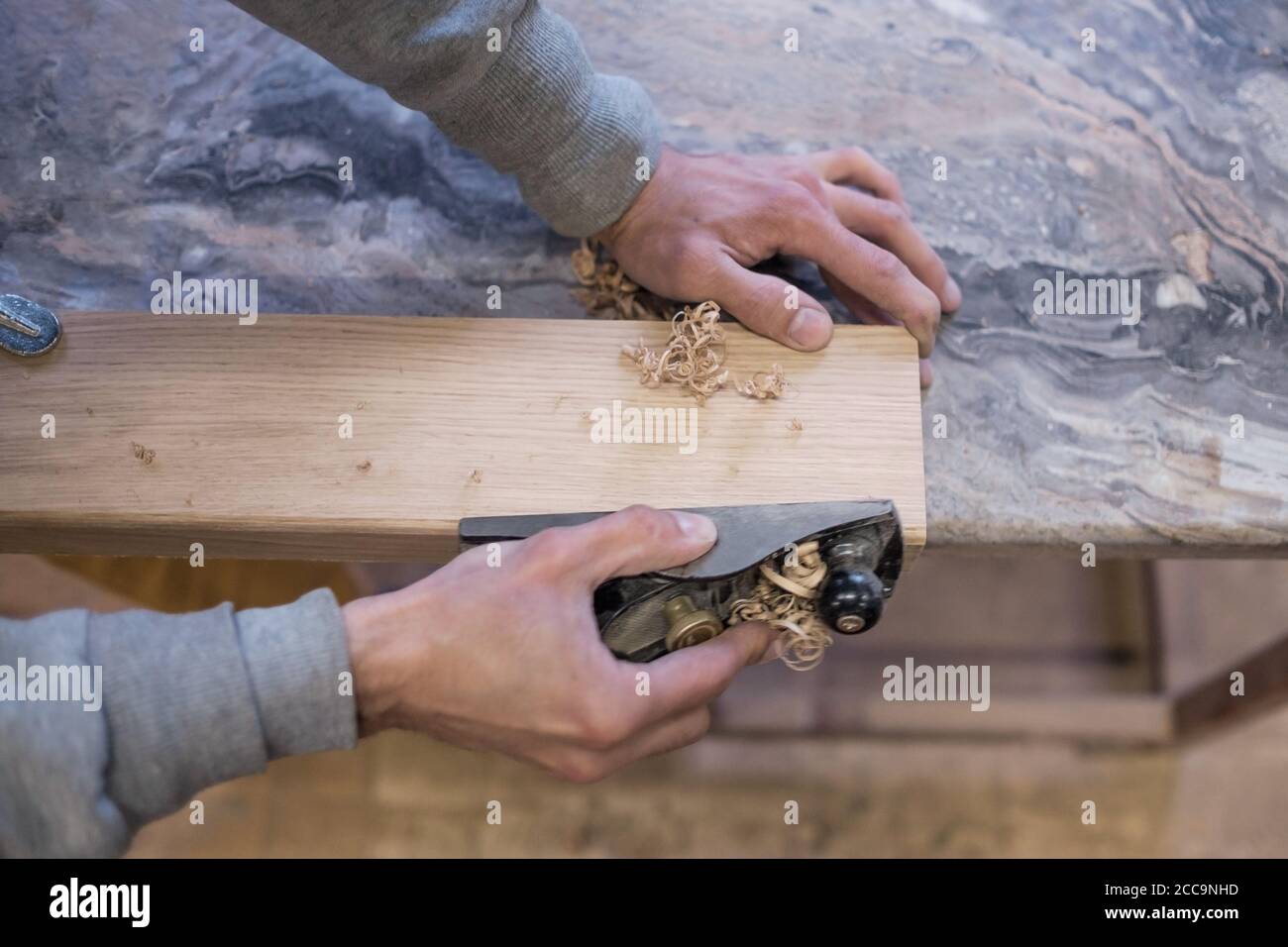 The carpenter is using a jointer. Top view. Stock Photo