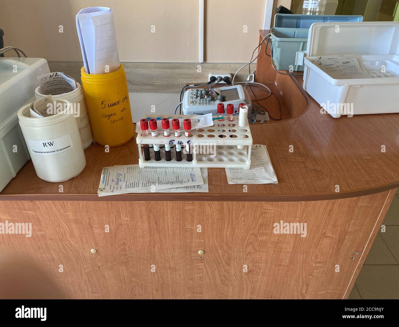 Oryol, Russia - August , 2020. Blood tests in test tubes in a container and medical forms at the hospital reception Stock Photo