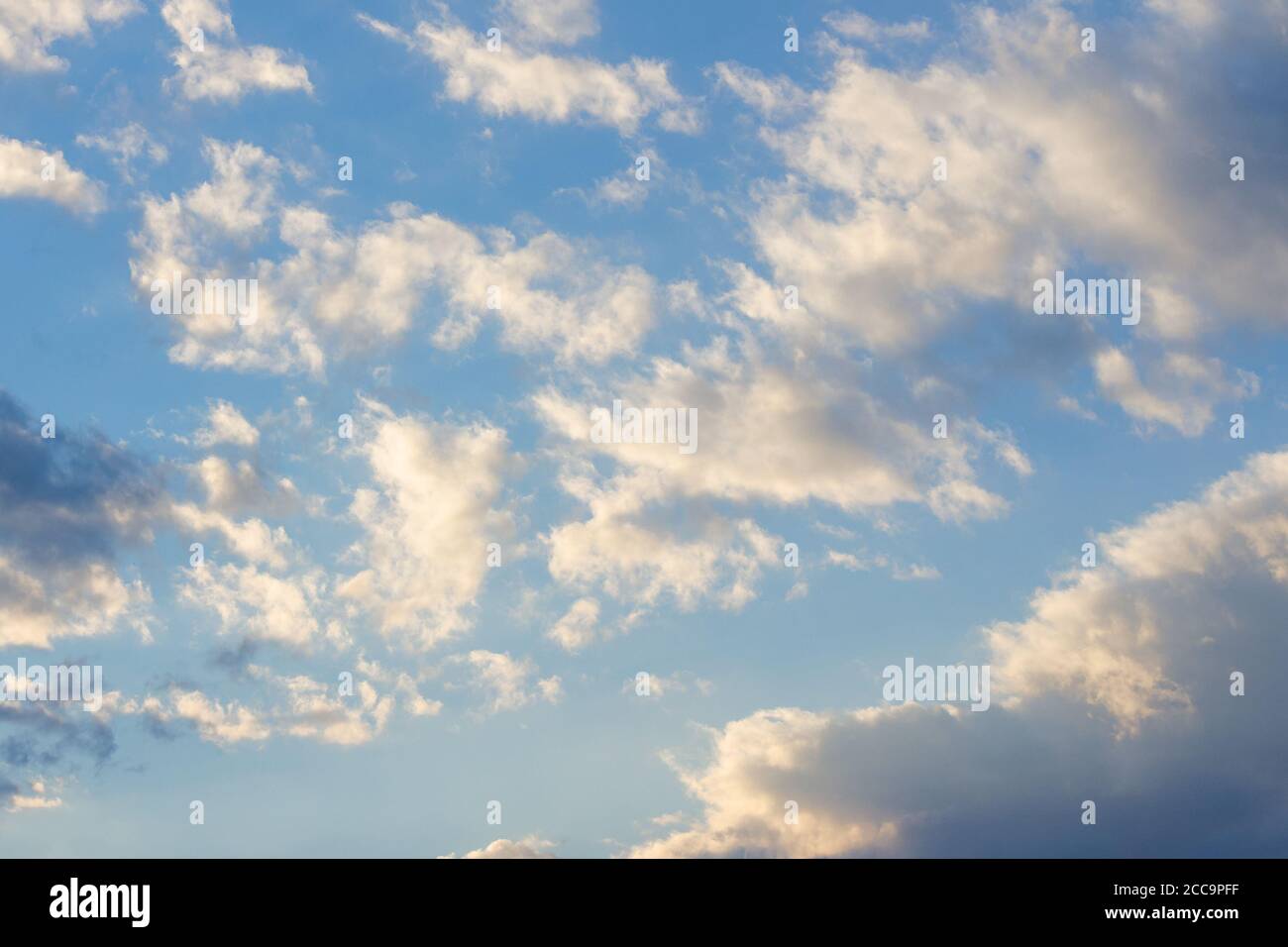 cloudy sky in yellow light. natural background at sunrise. inspiring scene Stock Photo