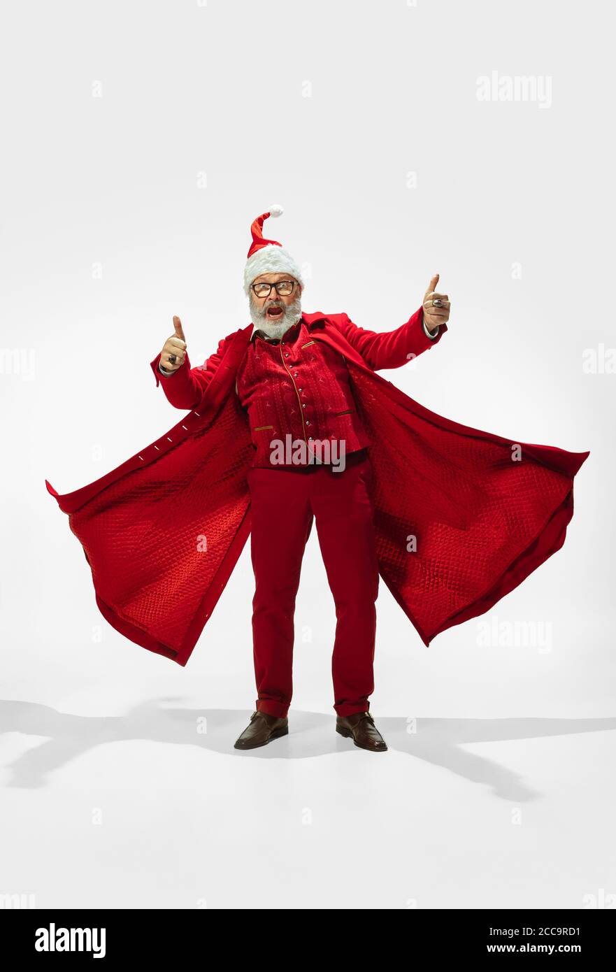 Thumb up. Modern stylish Santa Claus in red fashionable suit isolated ...