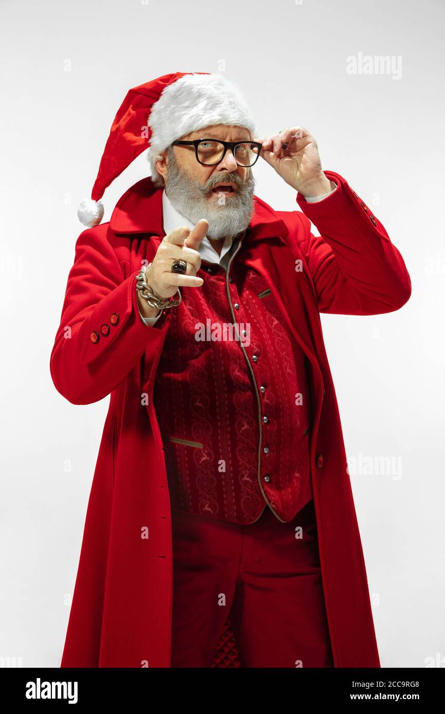Choosing you. Modern stylish Santa Claus in red fashionable suit isolated  on white background. Looks like a rockstar. New Year and Christmas eve,  celebration, holidays, winter's mood, fashion Stock Photo - Alamy