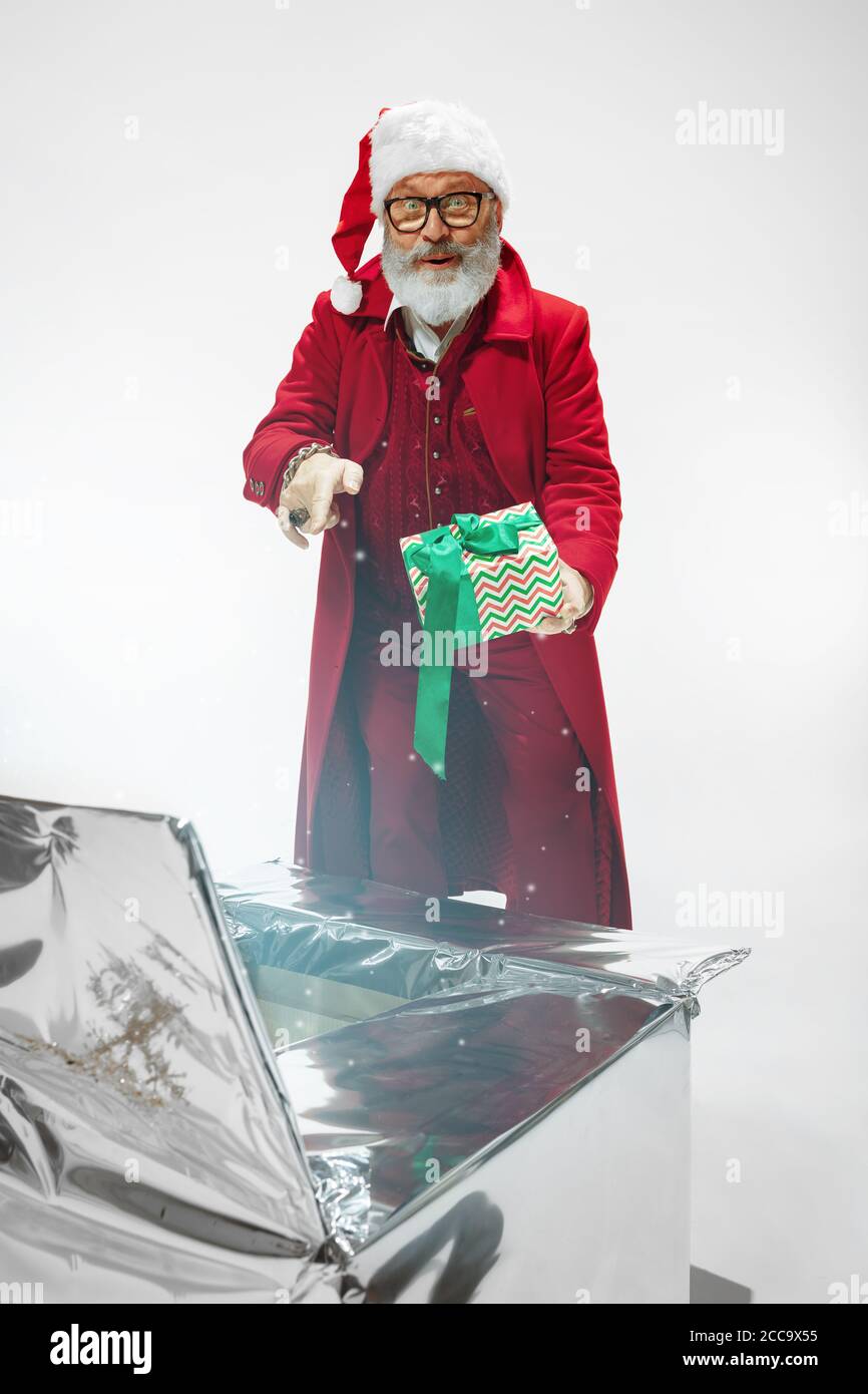 Gifts For 2021. Modern Stylish Santa Claus In Red Fashionable Suit And Cowboys  Hat On Dark Background. Looks Like A Rockstar. New Year And Christmas Eve,  Celebration, Holidays, Winters Mood, Fashion. Stock