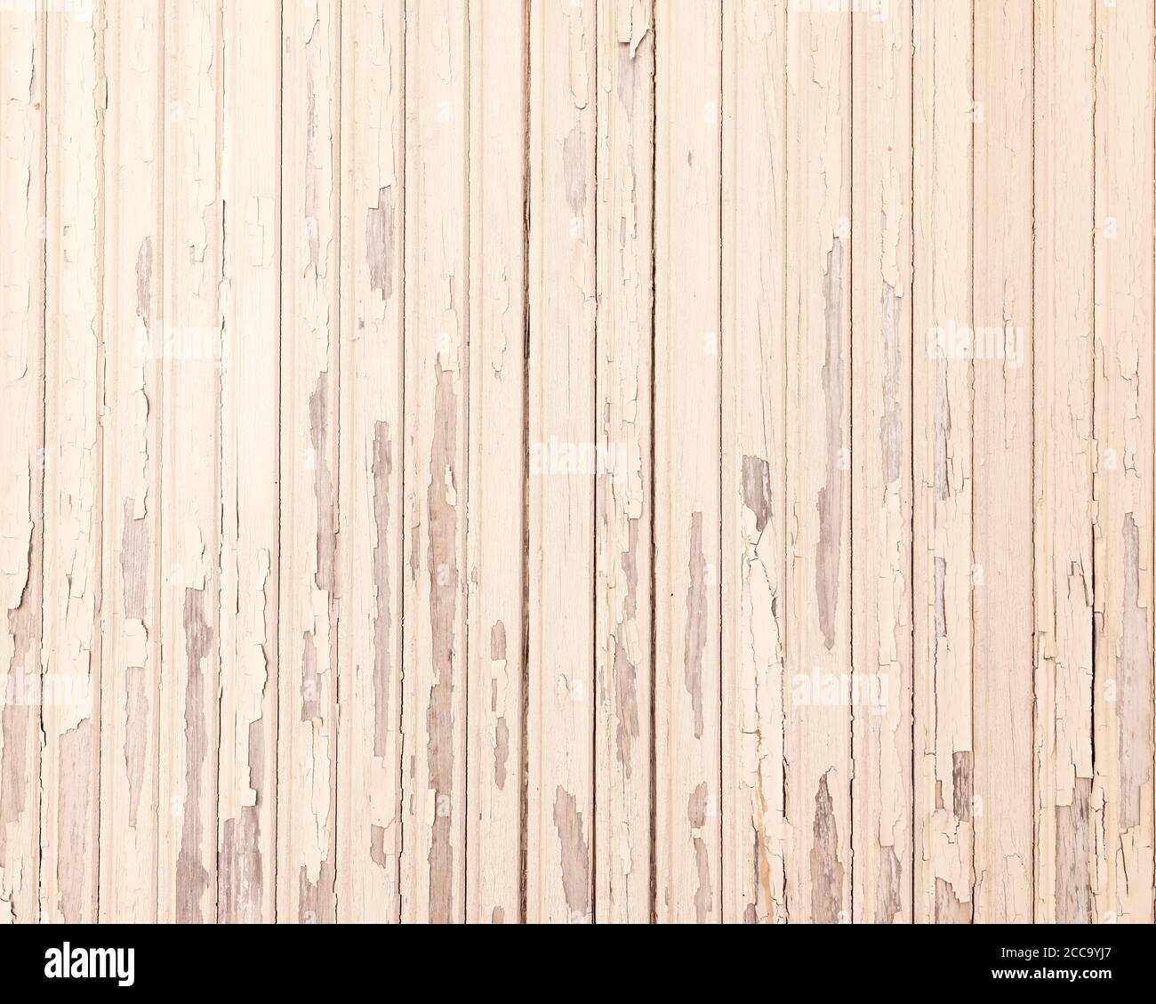 old beige grungy paint blisters on vertical wooden planks Stock Photo