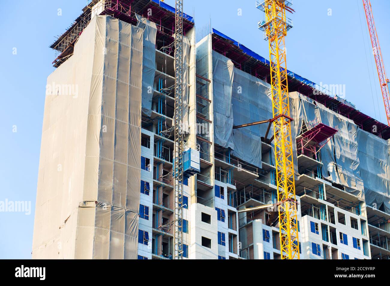 View of Construction building modern high rise condominium with crane against ...