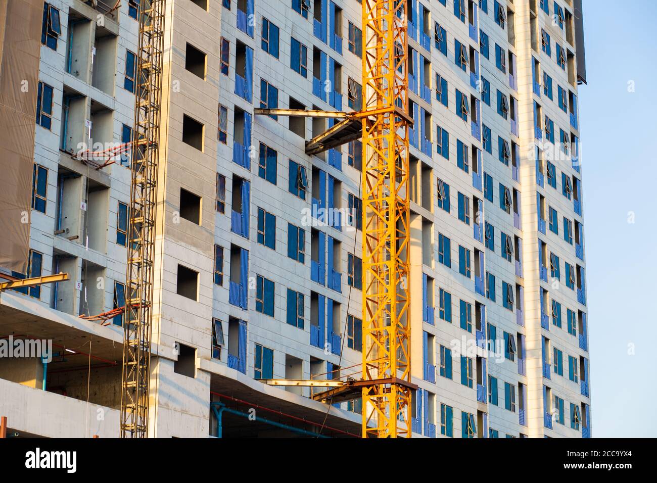 Image showcasing Construction building modern high rise condominium with crane against ...