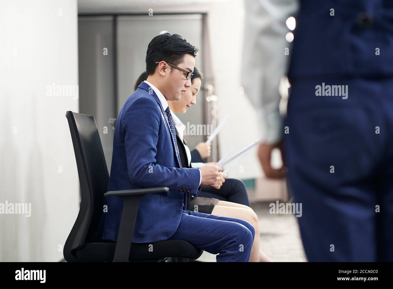 group of asian business people men and women waiting in line for job interview Stock Photo