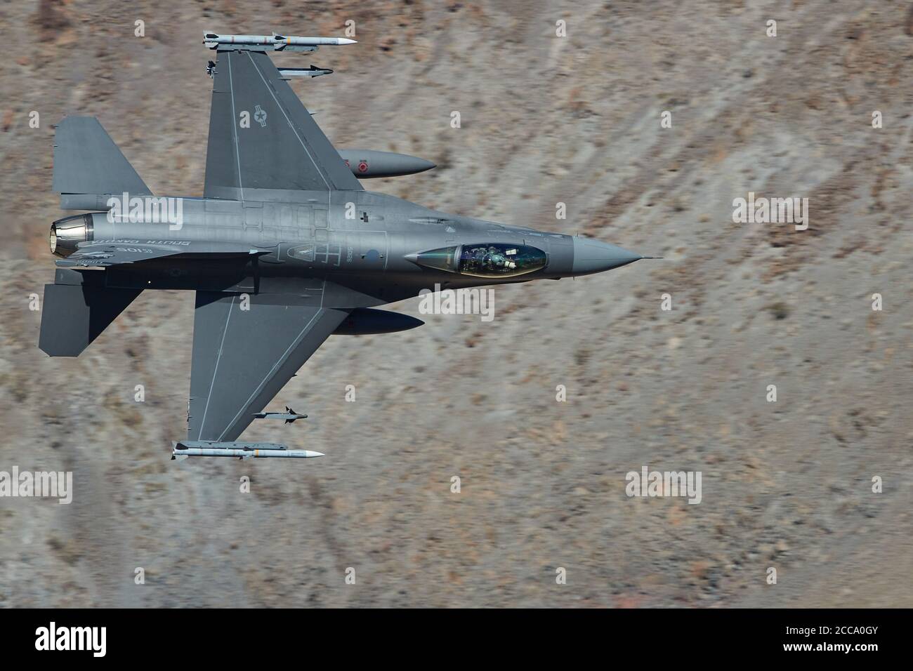 South Dakota Air National Guard, F-16, Fighting Falcon Jet Fighter Flying At Low Level And High Speed Through Rainbow Canyon, California. Stock Photo