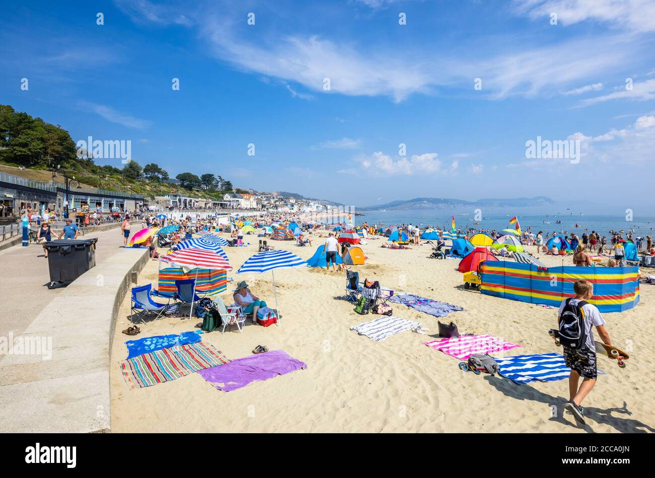 Family sunbathing beach lyme regis hi-res stock photography and images ...
