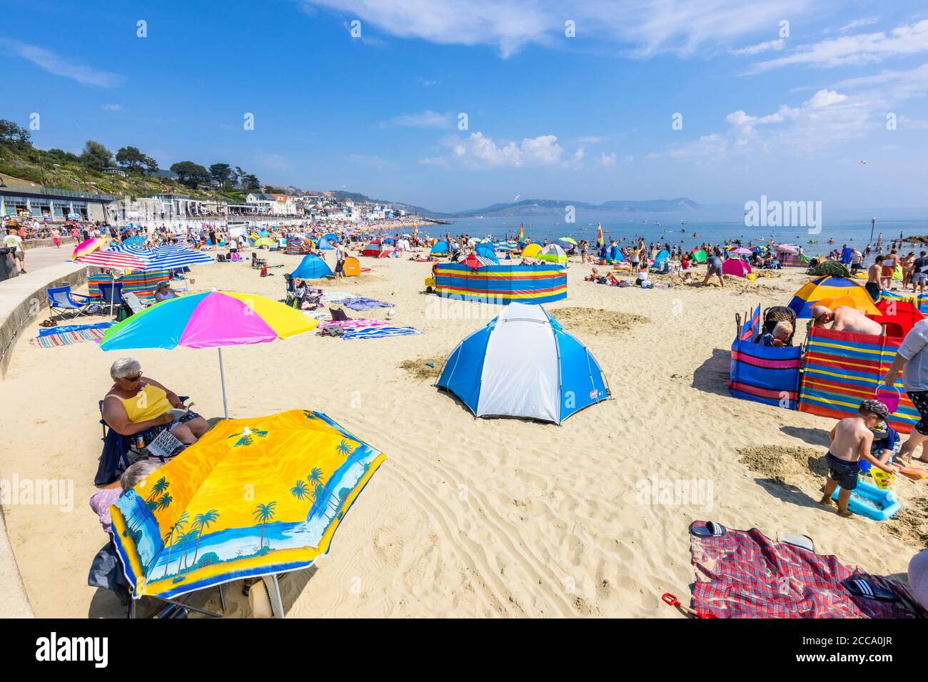 Family sunbathing beach lyme regis hi-res stock photography and images ...