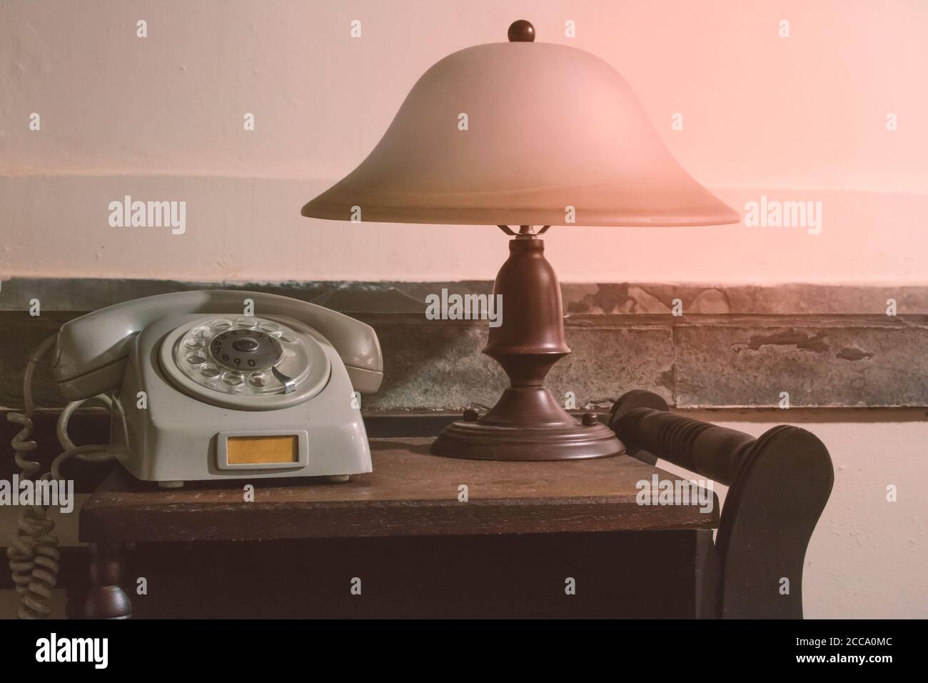 The lamp is on the desk. The lamp is on the desk