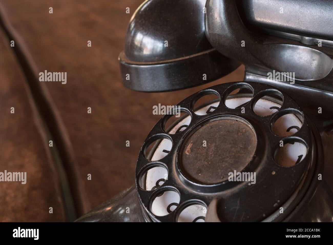 Old Beige phone retro on a wood table Stock Photo