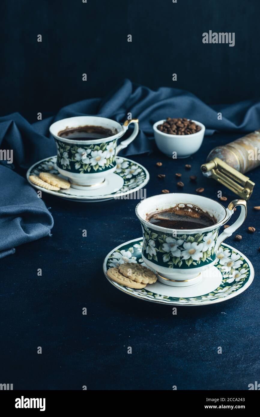 Two cups of brewed black coffee with tea biscuits. Stock Photo