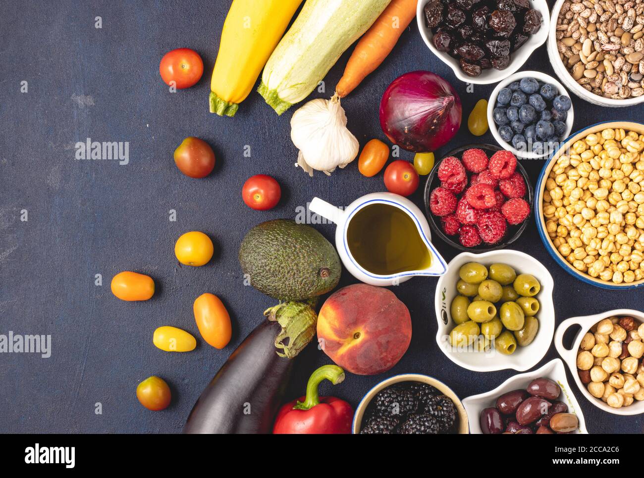 Top view of raw Mediterranean diet ingredients placed on dark background. Mediterranean food concept. Stock Photo