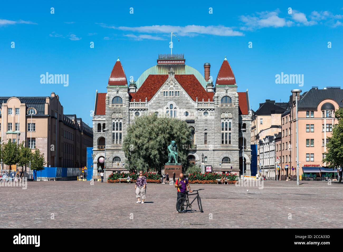 Finnish National Theater behind statue of Aleksis Kivi next Railway Station Square in Helsinki, Finland Stock Photo