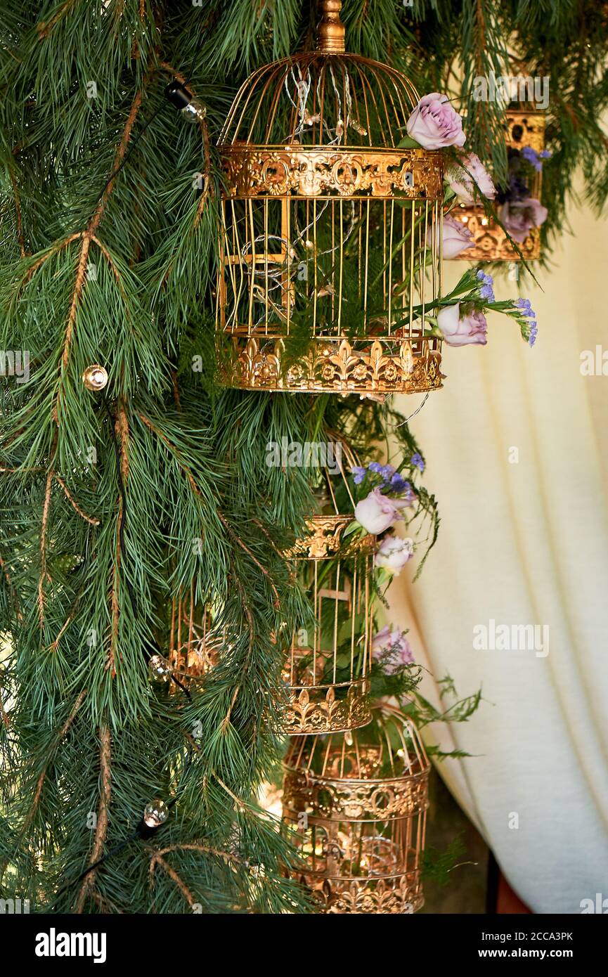 Wedding floristry.Eco style.Branches ate with golden cages and flowers