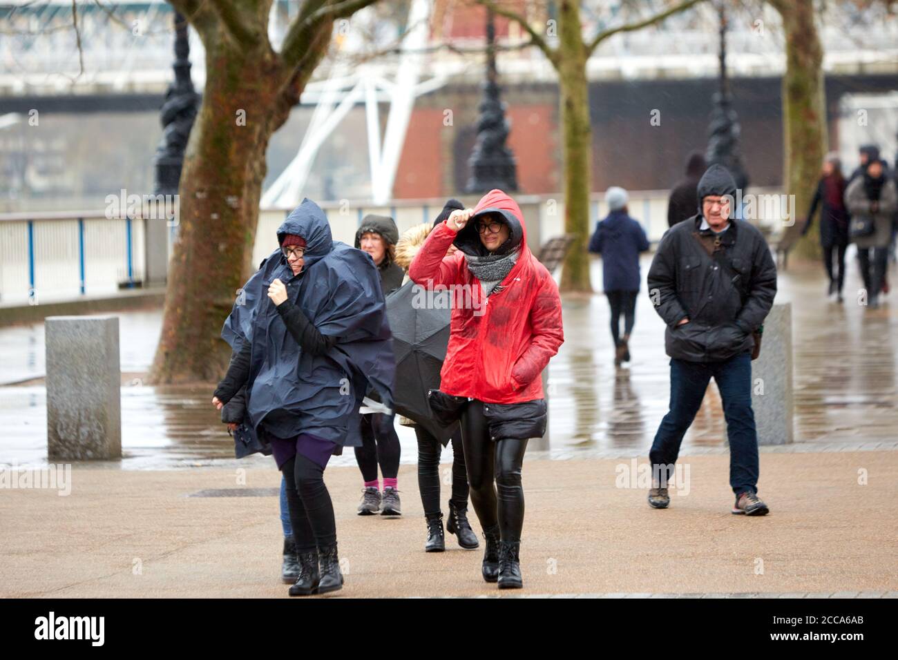 People battle the weather on the South Bank in London during high winds and rain caused by Storm Ciara Stock Photo