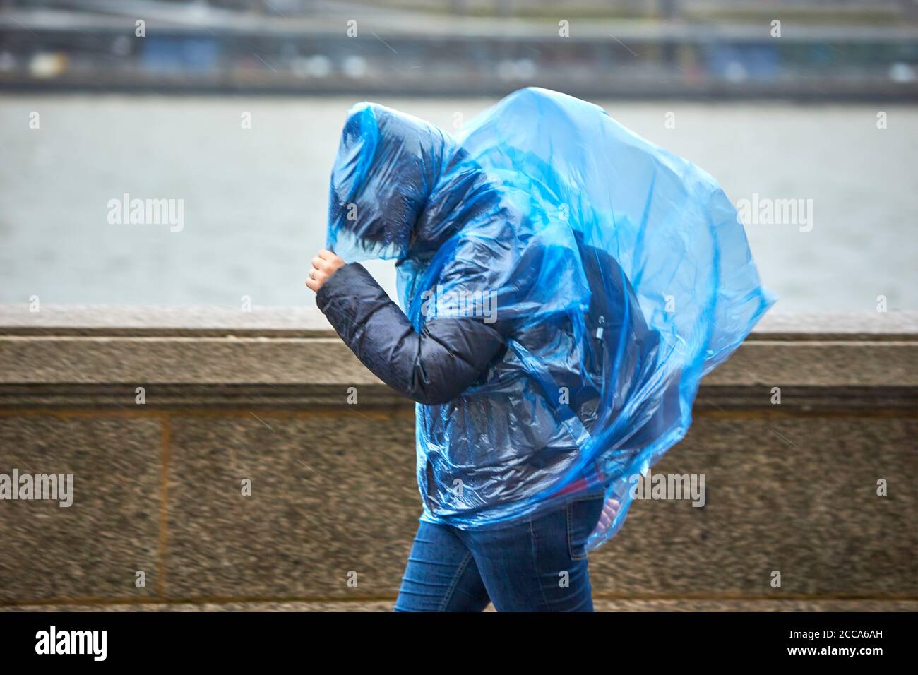 People battle the weather on the South Bank in London during high winds and rain caused by Storm Ciara Stock Photo