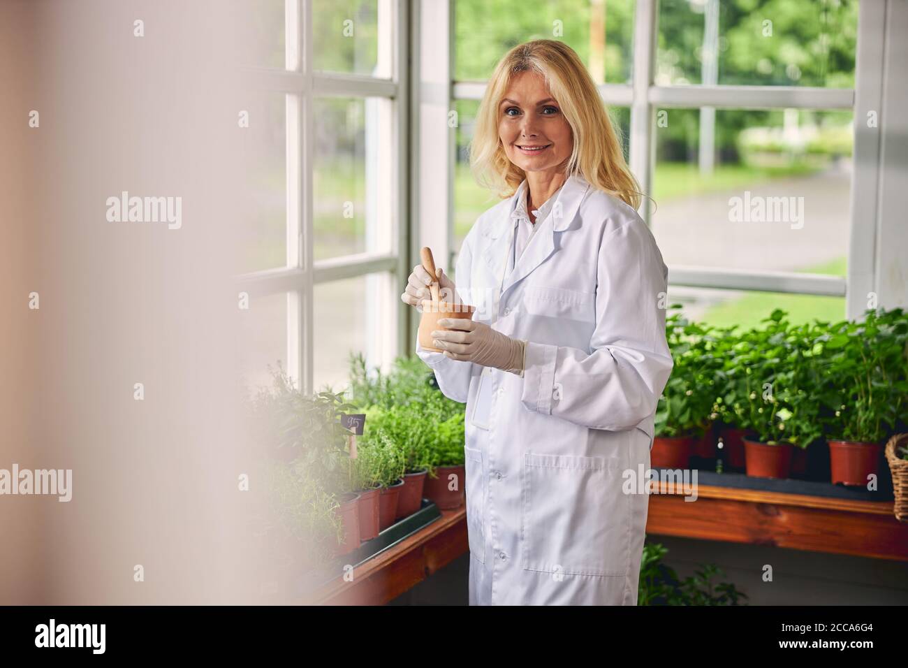 Pleased woman botanist working in a laboratory Stock Photo