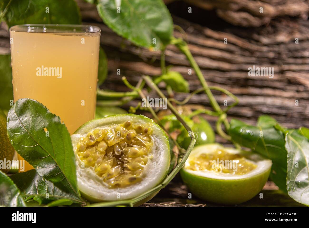 Tropical passion fruit juice. Fruit with essential nutrients for health well-being. Corresponds to a climbing plant of the Passifloraceae family Stock Photo