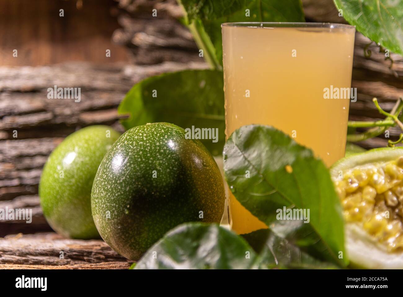 Tropical passion fruit juice. Fruit with essential nutrients for health well-being. Corresponds to a climbing plant of the Passifloraceae family Stock Photo